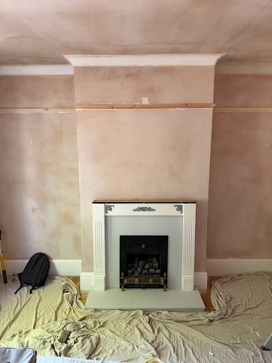 Freshly plastered chimney breast prepared for decoration